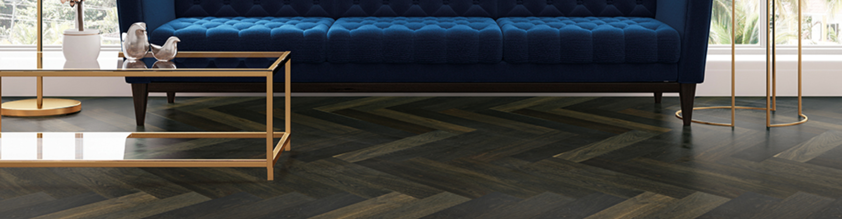 herringbone wood floor with blue velvet sofa