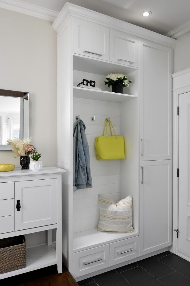 Entryway with hooks for storage, lighting and bench